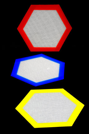 Three hexagon silicone dab mats—red, blue, yellow—displayed on black background highlighting textured center and bold colored borders.