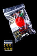 Black Apple Bags bundle printed with metallic gold skulls, loose bag underneath showing reflective design