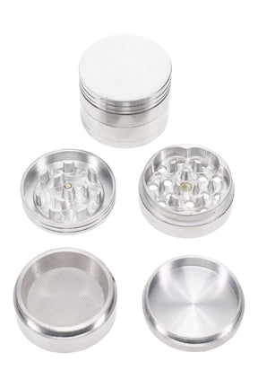 1¾″ 4-part metal herb grinder disassembled to show sharp teeth, magnetic lid, mesh pollen screen, and kief catch base.