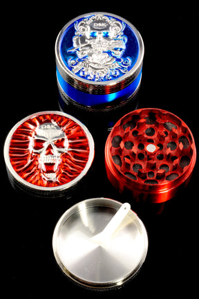 Red skull-lid 3-part metal grinder on black background with disassembled sections, mesh screen and catch tray visible.