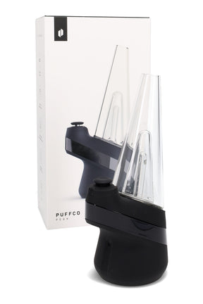 Puffco New Peak electric dab rig in black beside retail box, cone glass top and ergonomic base with single-button control.