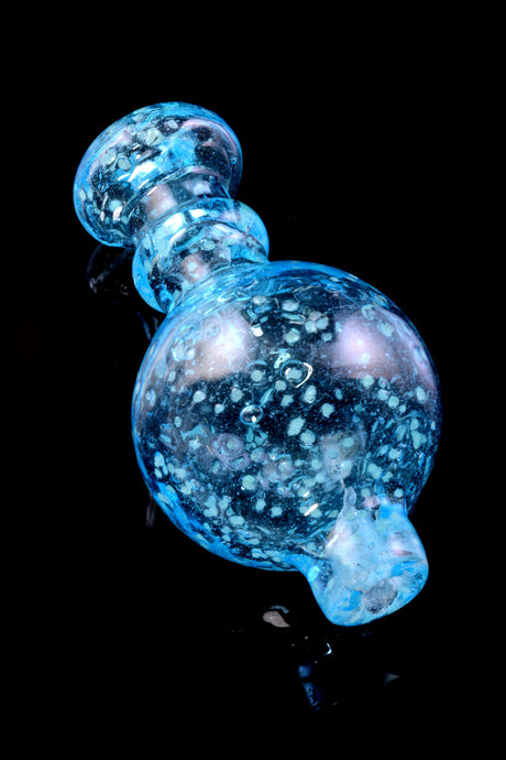 Blue glow-ready frit bubble carb cap highlighting rounded grip and polished spout for smooth, controlled draws at low temp.