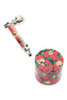 Rosy Skulls design metal pipe with matching 1½″ 4-part metal herb grinder gift set; bold floral skull pattern throughout.