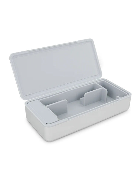 Empty Pivot travel case open to reveal soft silicone interior with modular compartments and covered trash pocket.