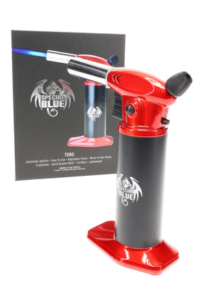 Red Special Blue Toro torch lighter standing beside retail box, angled left with chrome nozzle and wide base on white backdrop.