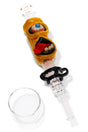Yellow one-eyed monster glass dab straw kit with tongue detail, black keck clip and clear concentrate dish.