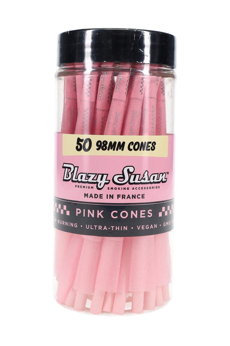 Clear jar of 50 Blazy Susan 98 mm pink pre-rolled cones with black screw-top lid and branded label, studio front view showing cone tips.