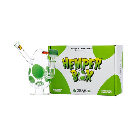 Green-spotted egg bong displayed with branded Hemper Box packaging on a studio-white backdrop.