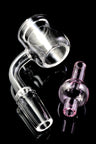 Close-up of quartz thermal bucket banger with 90° bend and pink bubble carb cap placed beside it on black.