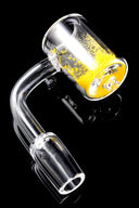 Quartz thermochromic banger showing yellow heat-sensitive crystals in the cup; 14.5 mm male joint and 90-degree bend on glossy black.