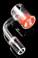 Clear quartz thermochromic banger with 14.5 mm male joint and 90° neck; red color-changing crystals in the bucket on a black background.