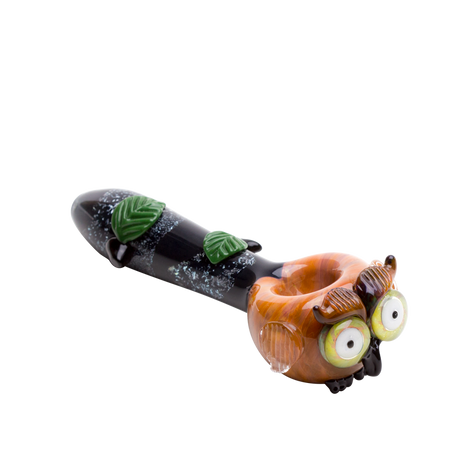 Three-quarter owl glass hand pipe with glossy amber face, raised wings, dark stem, and leafy details