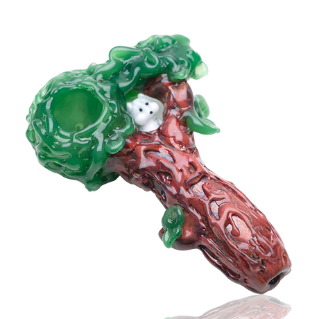 Tree-trunk spoon hand pipe with sculpted leaves, deep green bowl, and squirrel peeking from the nest